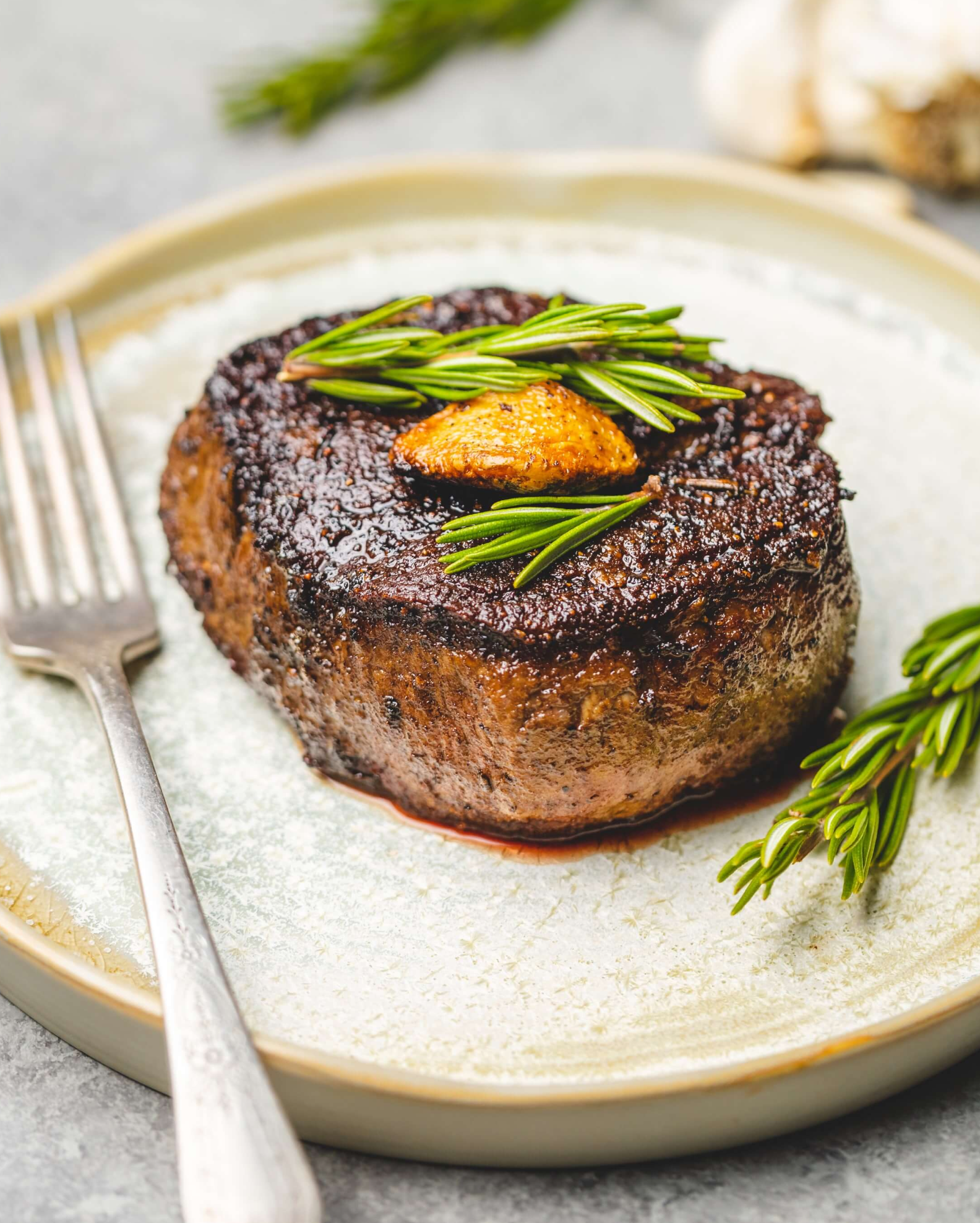 Main courses menu image with a picture of steak and rosemary